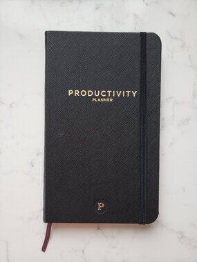 black hardcover Productivity Planner, daily weekly goal organizer